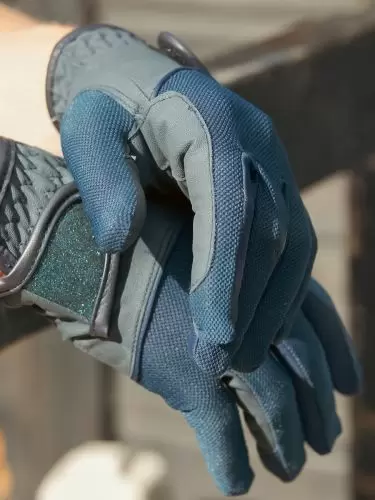 Horse rider wearing a pair of Summer-Weight Horse Riding Gloves in navy by Just Chaps