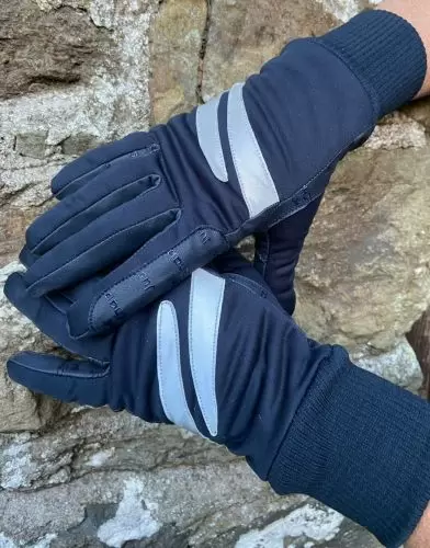 Horse rider by stone wall wearing a pair of Winter Riding Gloves in navy by Just Chaps