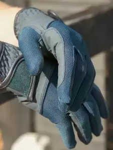 Horse rider wearing a pair of Summer-Weight Horse Riding Gloves in navy by Just Chaps