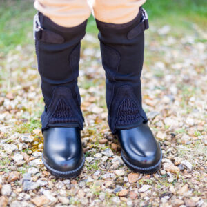 child wearing black all purpose half chaps