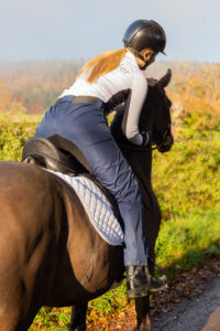 lady riding a horse wearing dri-rider waterproof trousers